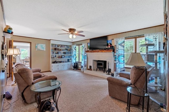 carpeted living room with ceiling fan, a healthy amount of sunlight, built in features, and a textured ceiling