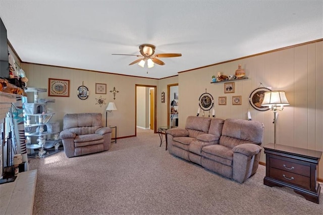 carpeted living room with crown molding and ceiling fan