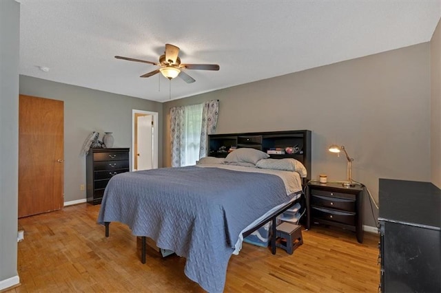 bedroom with light hardwood / wood-style floors and ceiling fan