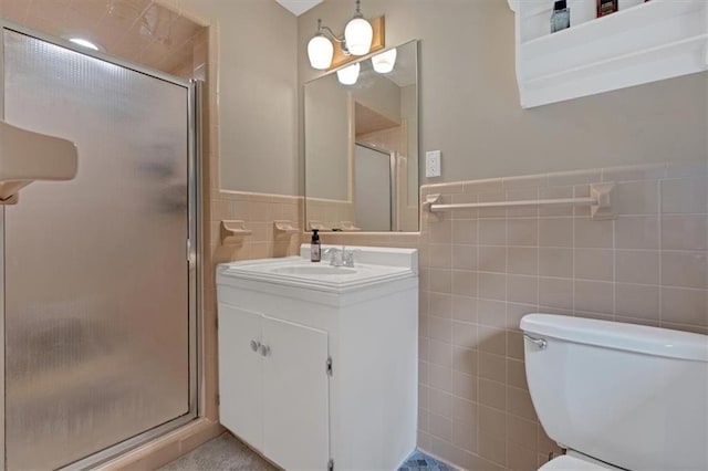 bathroom with vanity, tile walls, an enclosed shower, and toilet