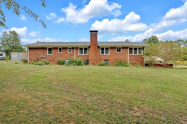 back of house with a lawn