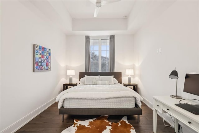 bedroom featuring dark wood-style floors, ceiling fan, and baseboards