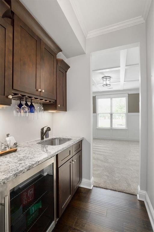 2103 Sourwood Ct, Monroe, GA 30656 - bar area featuring beverage cooler, dark colored carpet, crown molding, dark wood-style flooring, and beamed ceiling