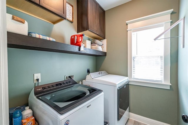 2103 Sourwood Ct, Monroe, GA 30656 - laundry room featuring cabinet space, healthy amount of natural light, and washer and dryer