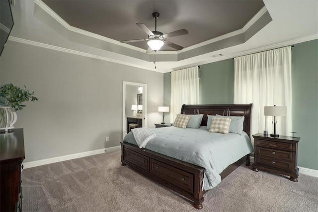 2103 Sourwood Ct, Monroe, GA 30656 - carpeted bedroom featuring a tray ceiling, ornamental molding, and ceiling fan