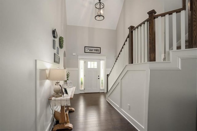 2103 Sourwood Ct, Monroe, GA 30656 - entryway featuring high vaulted ceiling, stairway, and dark wood-style flooring