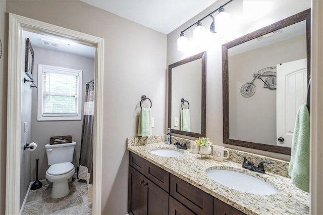 2103 Sourwood Ct, Monroe, GA 30656 - bathroom featuring toilet and double vanity