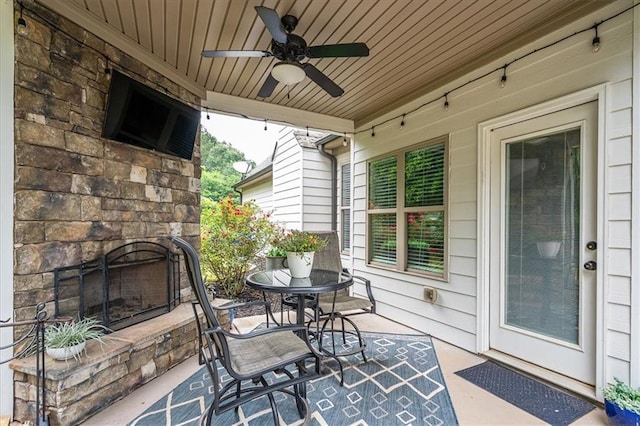 2103 Sourwood Ct, Monroe, GA 30656 - view of patio featuring a ceiling fan and an outdoor stone fireplace