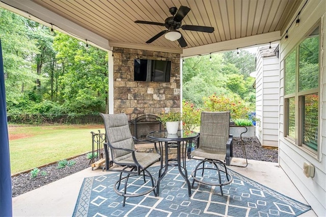 2103 Sourwood Ct, Monroe, GA 30656 - view of patio / terrace featuring an outdoor stone fireplace, a ceiling fan, and outdoor dining space