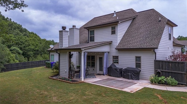 2103 Sourwood Ct, Monroe, GA 30656 - rear view of property with a chimney, a patio area, a shingled roof, and a fenced backyard