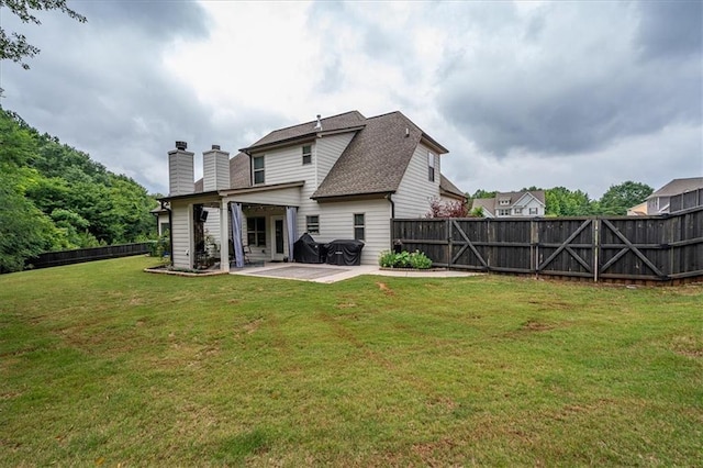 2103 Sourwood Ct, Monroe, GA 30656 - back of property featuring a patio area, a chimney, and a fenced backyard