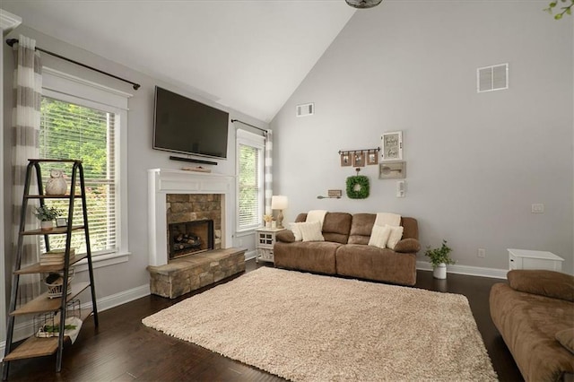2103 Sourwood Ct, Monroe, GA 30656 - living room featuring plenty of natural light, dark wood-type flooring, high vaulted ceiling, and a stone fireplace