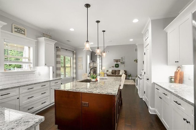 2103 Sourwood Ct, Monroe, GA 30656 - kitchen featuring backsplash, white cabinetry, ornamental molding, recessed lighting, and dark wood-style floors