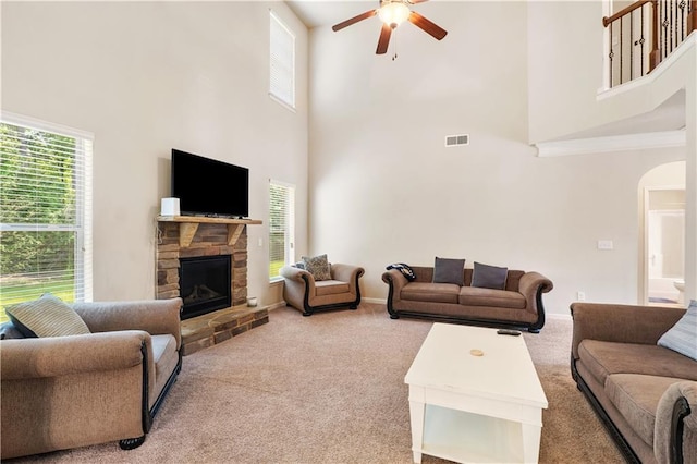 7946 White Oak Loop, Stonecrest, GA 30038 - carpeted living area with a towering ceiling, ceiling fan, arched walkways, and plenty of natural light