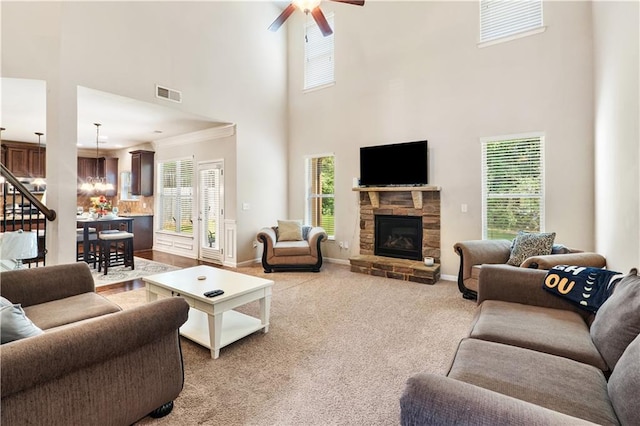 7946 White Oak Loop, Stonecrest, GA 30038 - living area with a high ceiling, healthy amount of natural light, a stone fireplace, a ceiling fan, and baseboards