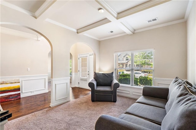 7946 White Oak Loop, Stonecrest, GA 30038 - carpeted living room featuring arched walkways, beam ceiling, a wainscoted wall, coffered ceiling, and ornamental molding