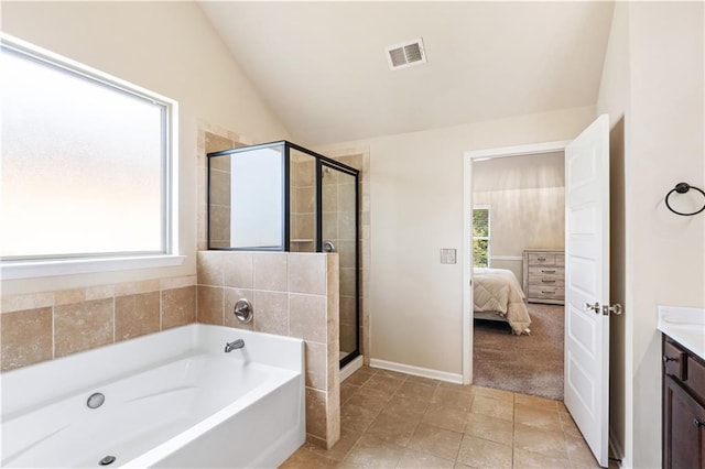 7946 White Oak Loop, Stonecrest, GA 30038 - ensuite bathroom featuring a garden tub, vanity, a shower stall, vaulted ceiling, and tile patterned floors