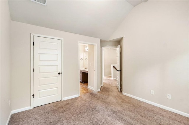7946 White Oak Loop, Stonecrest, GA 30038 - unfurnished bedroom featuring lofted ceiling, carpet, and baseboards