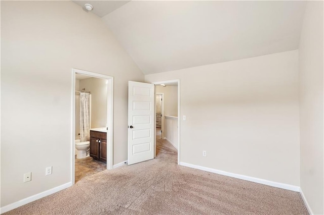 7946 White Oak Loop, Stonecrest, GA 30038 - unfurnished bedroom featuring light colored carpet, vaulted ceiling, baseboards, and connected bathroom