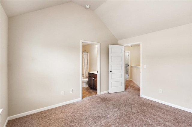 7946 White Oak Loop, Stonecrest, GA 30038 - unfurnished bedroom with vaulted ceiling, carpet floors, baseboards, and ensuite bath