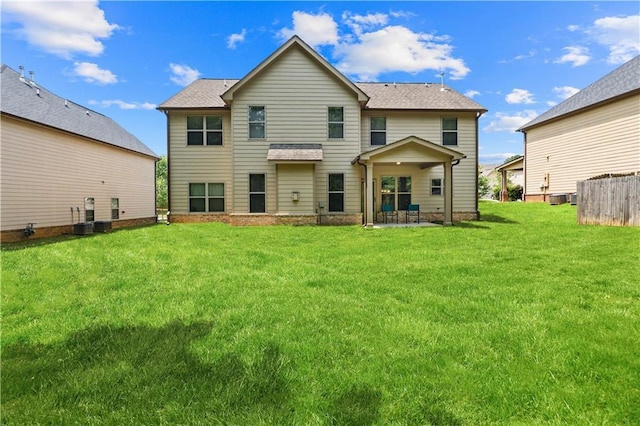 7946 White Oak Loop, Stonecrest, GA 30038 - back of house featuring a patio, a lawn, roof with shingles, and cooling unit