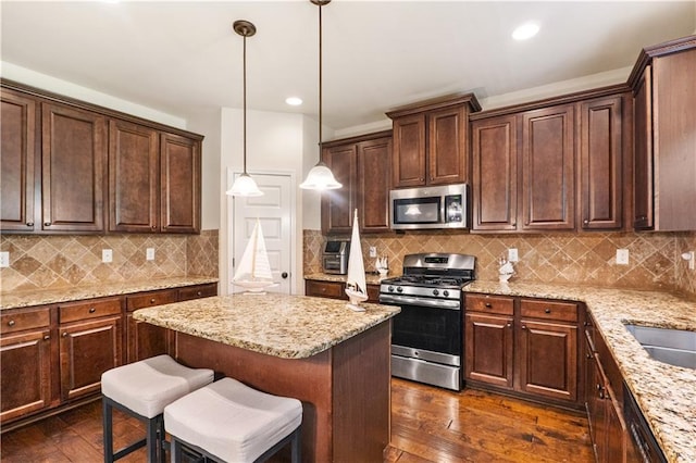 7946 White Oak Loop, Stonecrest, GA 30038 - kitchen featuring appliances with stainless steel finishes, light stone counters, dark wood finished floors, dark brown cabinets, and recessed lighting
