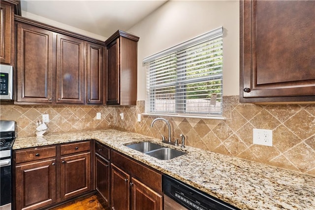7946 White Oak Loop, Stonecrest, GA 30038 - kitchen with a sink, stainless steel appliances, light stone counters, dark brown cabinets, and tasteful backsplash