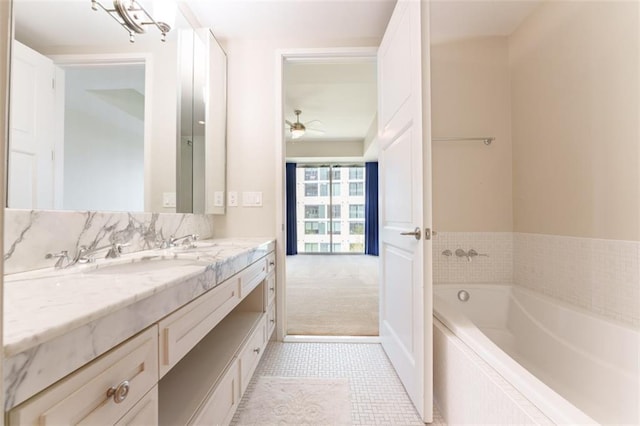 bathroom featuring a bath, ceiling fan, tile patterned flooring, and vanity