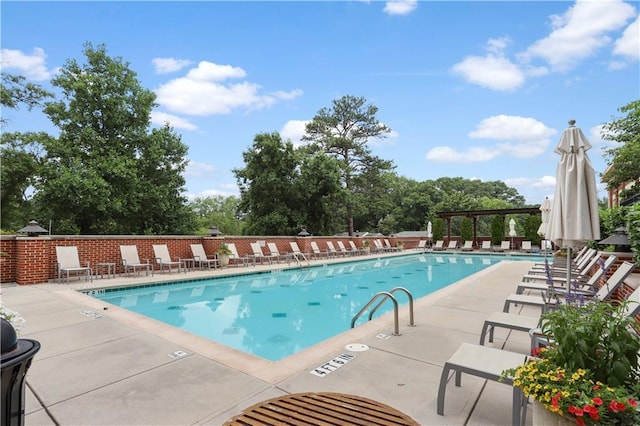 pool with a pergola and a patio area