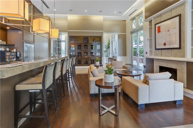 living area featuring dark wood-style floors and a high end fireplace