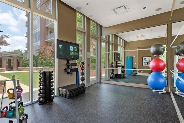 workout area featuring a high ceiling and visible vents