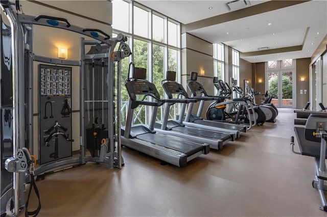 exercise room with visible vents and floor to ceiling windows