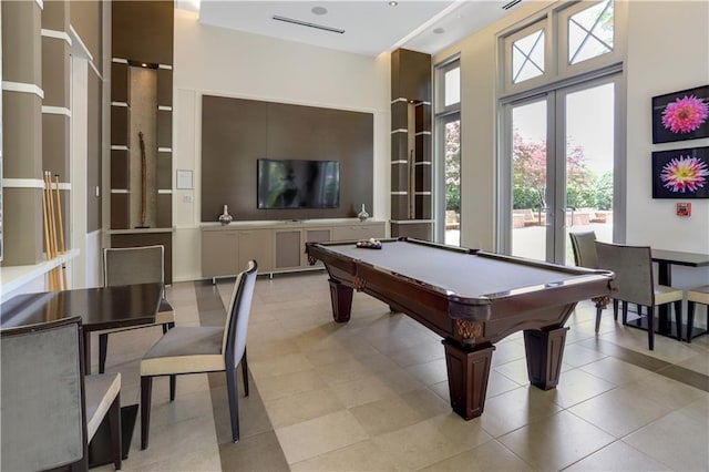 recreation room featuring french doors, light tile patterned flooring, pool table, and a high ceiling