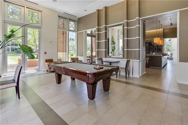 rec room featuring a towering ceiling, recessed lighting, light tile patterned floors, and billiards