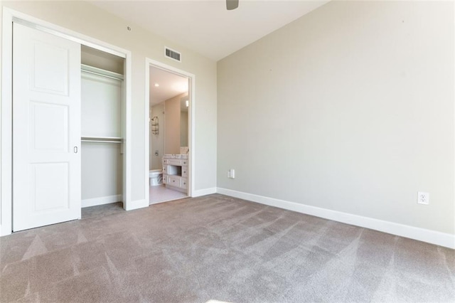 unfurnished bedroom with baseboards, carpet flooring, connected bathroom, and visible vents