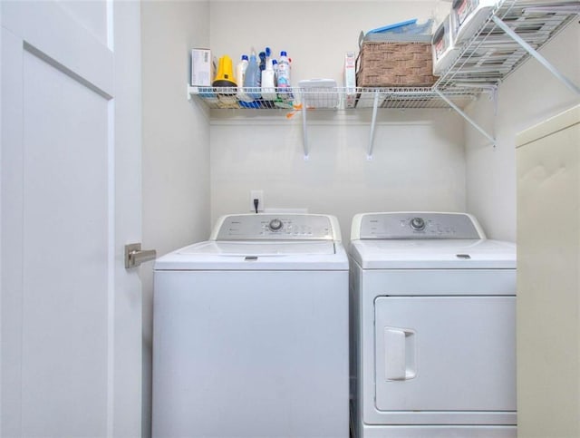 laundry area with independent washer and dryer