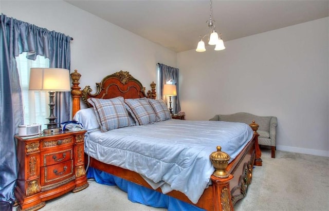 carpeted bedroom featuring a notable chandelier