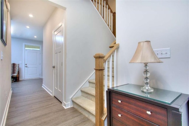 stairs with hardwood / wood-style floors