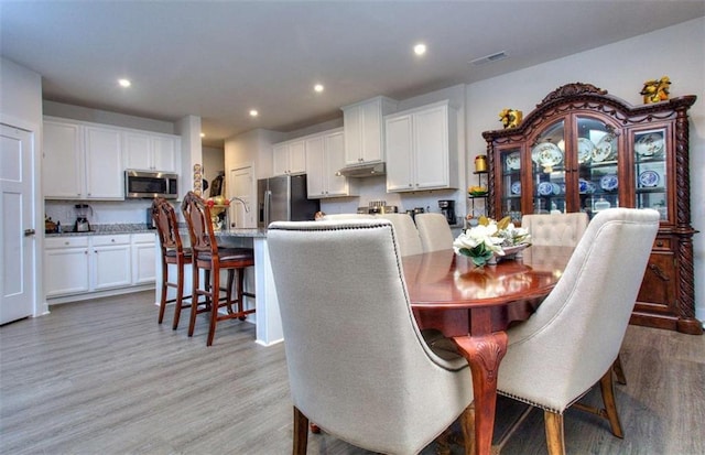 dining space featuring light hardwood / wood-style floors