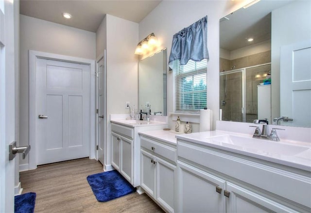 bathroom with vanity, hardwood / wood-style floors, and walk in shower