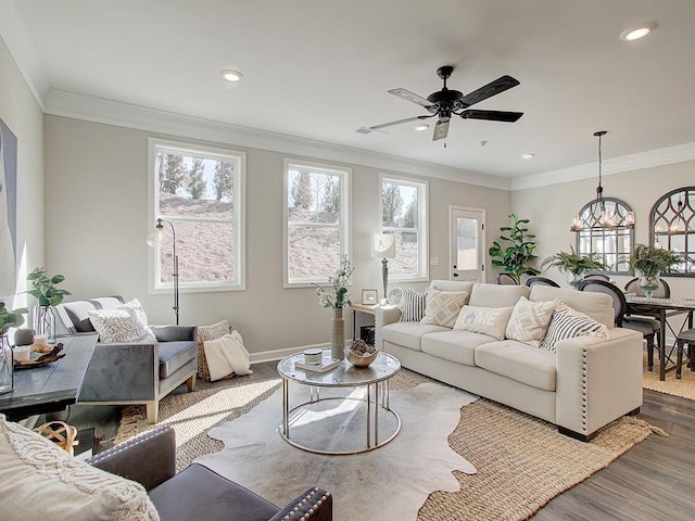 living room with hardwood / wood-style flooring, ceiling fan, and ornamental molding