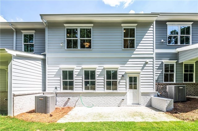 rear view of house with a patio and central air condition unit