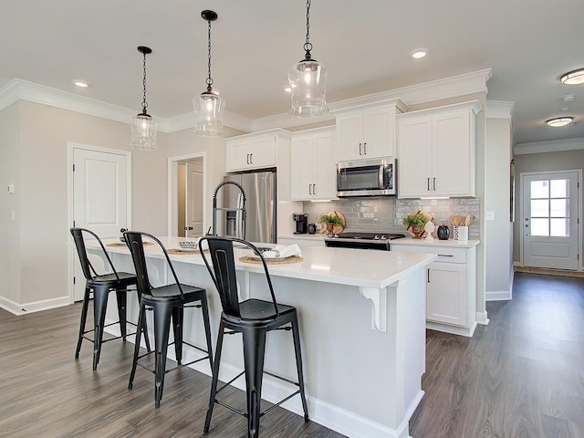 kitchen with white cabinetry, stainless steel appliances, and an island with sink