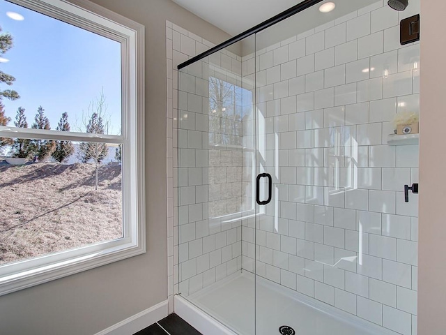 bathroom featuring a wealth of natural light and a shower with door