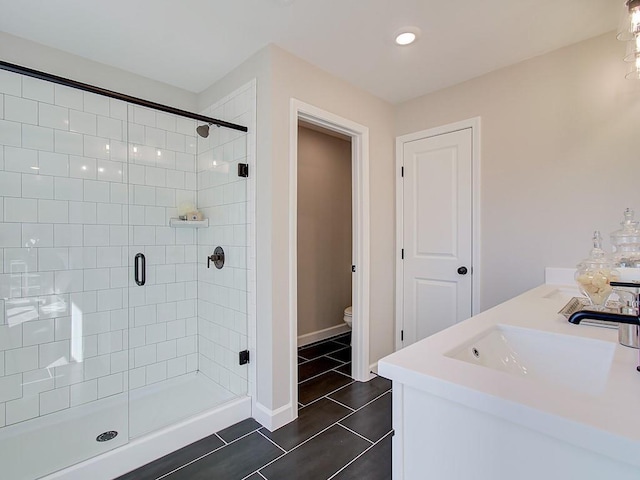 bathroom with vanity, toilet, an enclosed shower, and tile patterned flooring