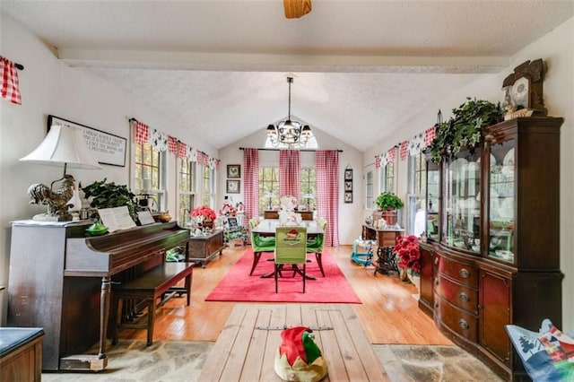 interior space featuring hardwood / wood-style flooring, lofted ceiling with beams, and a chandelier