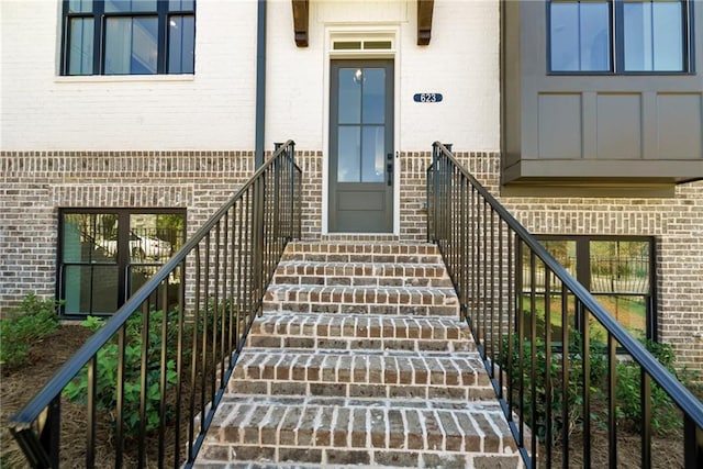 doorway to property with brick siding