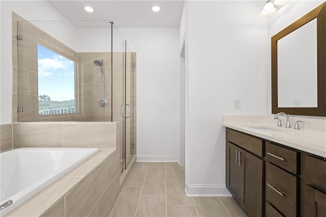full bathroom with vanity, baseboards, recessed lighting, a shower stall, and a bath