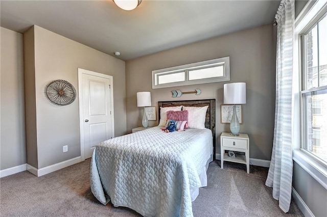 bedroom with carpet floors and baseboards