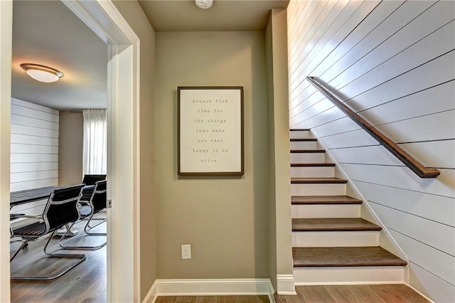 stairway with baseboards and wood finished floors